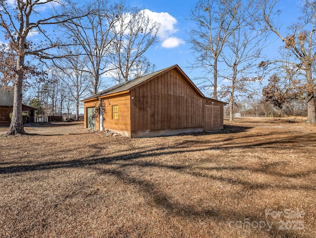 view of side of home with a yard and an outbuilding