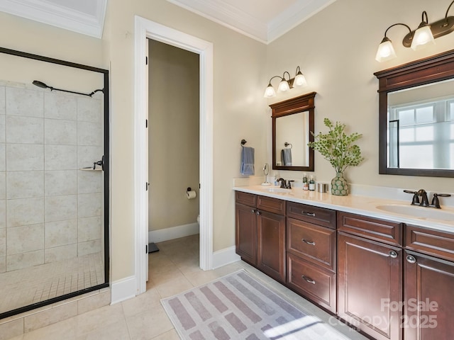 bathroom with tile patterned flooring, vanity, crown molding, and a tile shower