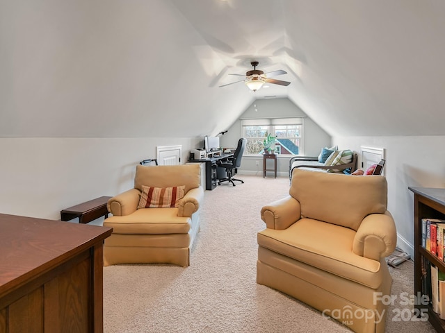 interior space featuring lofted ceiling, ceiling fan, and carpet