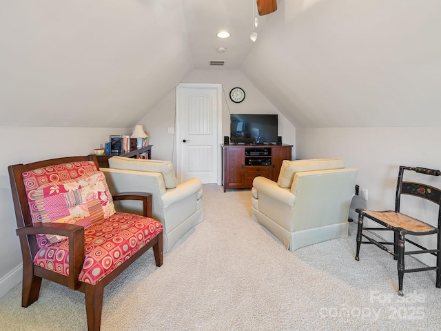 sitting room featuring vaulted ceiling and light carpet