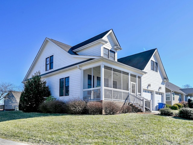 view of home's exterior with a garage, a sunroom, and a yard