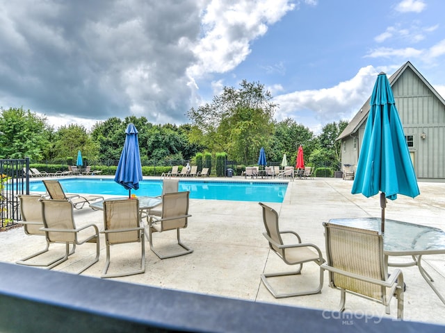 view of swimming pool featuring a patio area