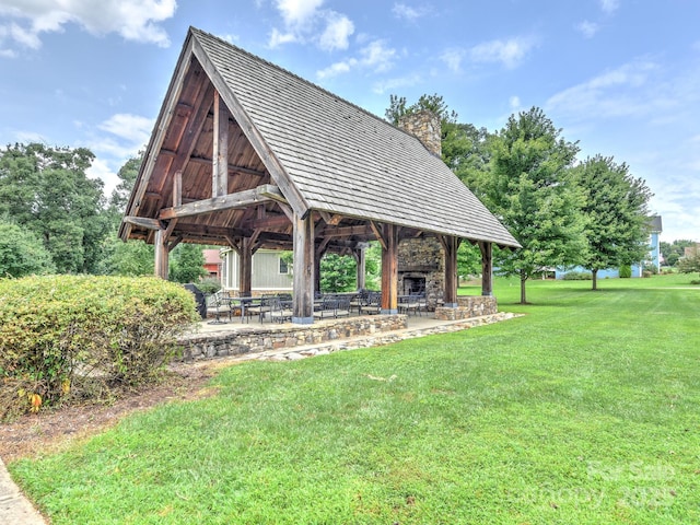 view of home's community featuring a patio and a lawn