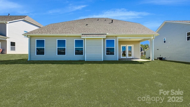 rear view of house with french doors, central air condition unit, and a lawn