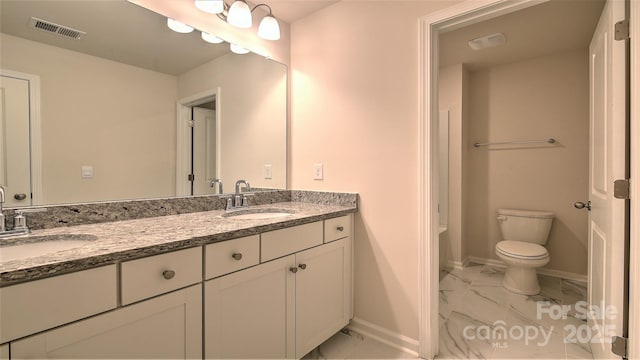 bathroom with vanity and toilet