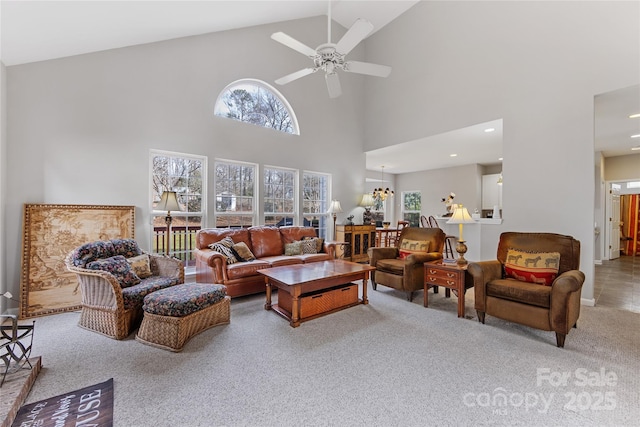 carpeted living room with ceiling fan and lofted ceiling