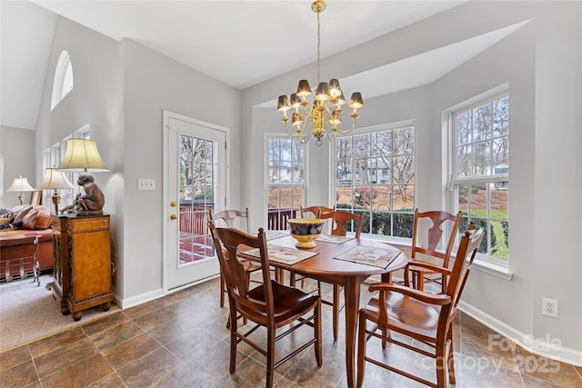 dining space with a healthy amount of sunlight and a notable chandelier