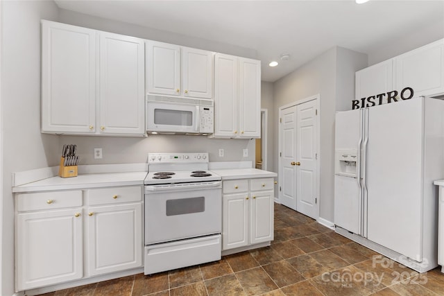 kitchen featuring white cabinetry and white appliances