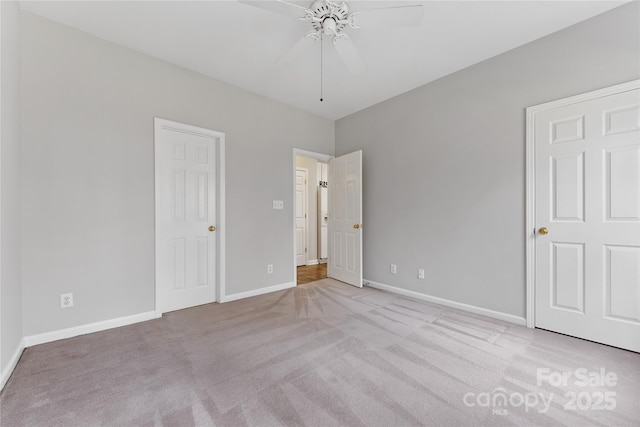 unfurnished bedroom with ceiling fan and light colored carpet