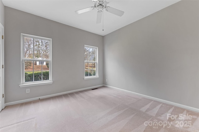 carpeted spare room with plenty of natural light and ceiling fan