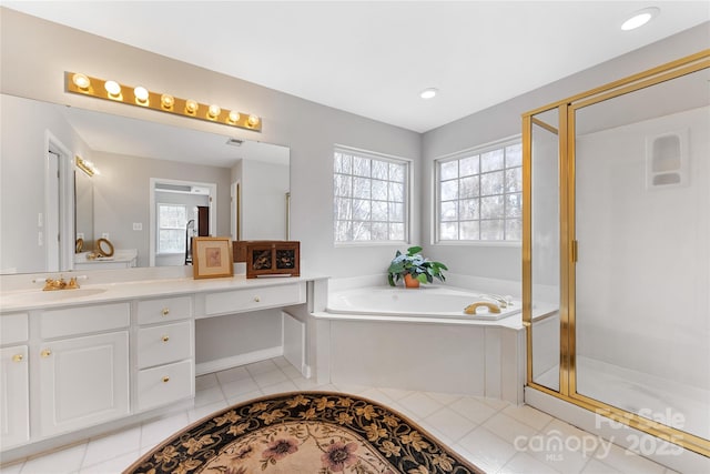 bathroom featuring tile patterned floors, independent shower and bath, and vanity