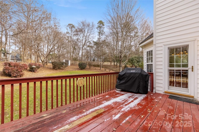 deck featuring area for grilling and a lawn