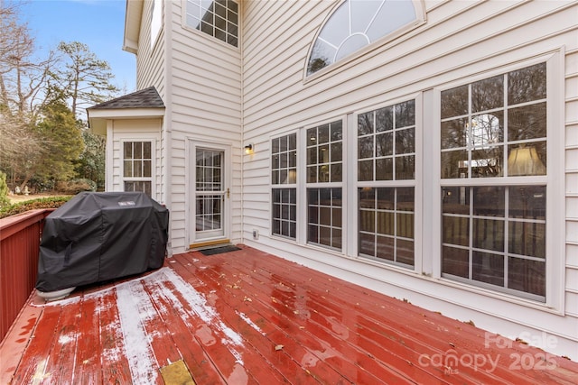 wooden deck featuring a grill