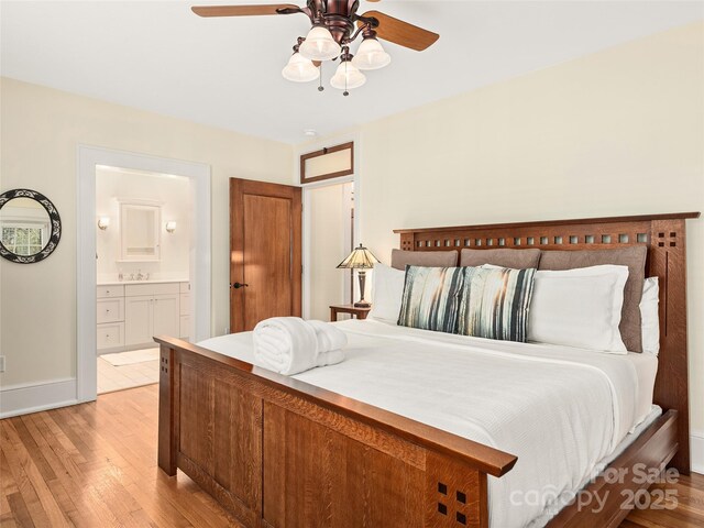 203 6th Ave W Unit 1B, Hendersonville, NC 28739 - bedroom with light wood-style flooring, ensuite bath, and a ceiling fan