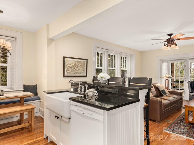 203 6th Ave W Unit 1B, Hendersonville, NC 28739 - kitchen with dishwasher, dark countertops, light wood-style floors, and white cabinets