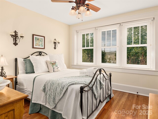 203 6th Ave W Unit 1B, Hendersonville, NC 28739 - bedroom with multiple windows, wood finished floors, and a ceiling fan