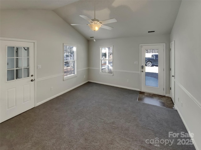 carpeted entryway featuring lofted ceiling and ceiling fan