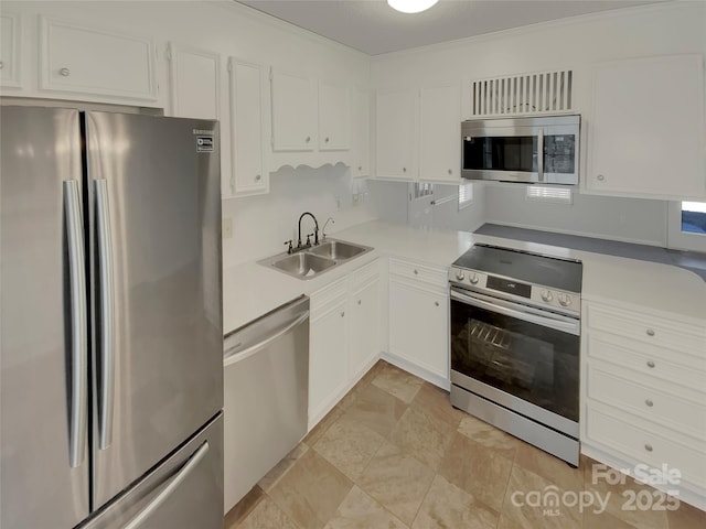 kitchen with white cabinets, appliances with stainless steel finishes, and sink