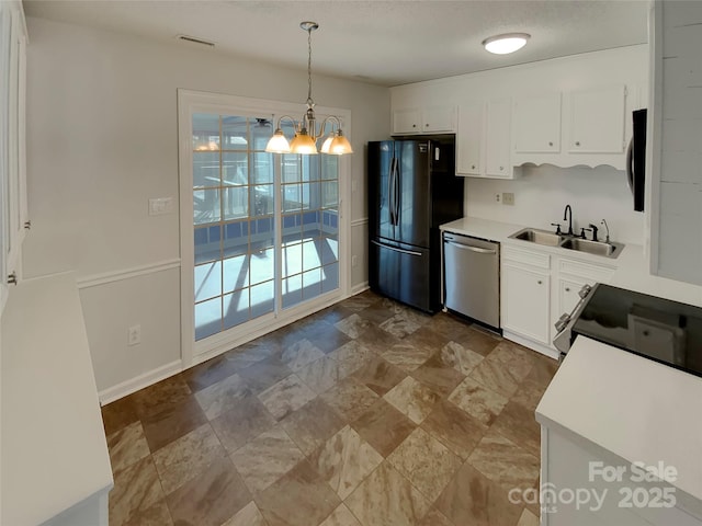 kitchen featuring stainless steel dishwasher, black refrigerator, an inviting chandelier, white cabinets, and sink