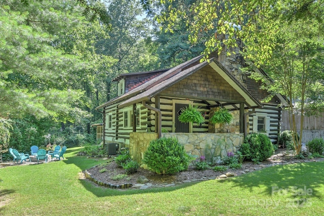 view of property exterior featuring central AC unit and a lawn