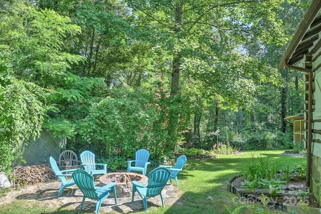 view of yard with an outdoor fire pit