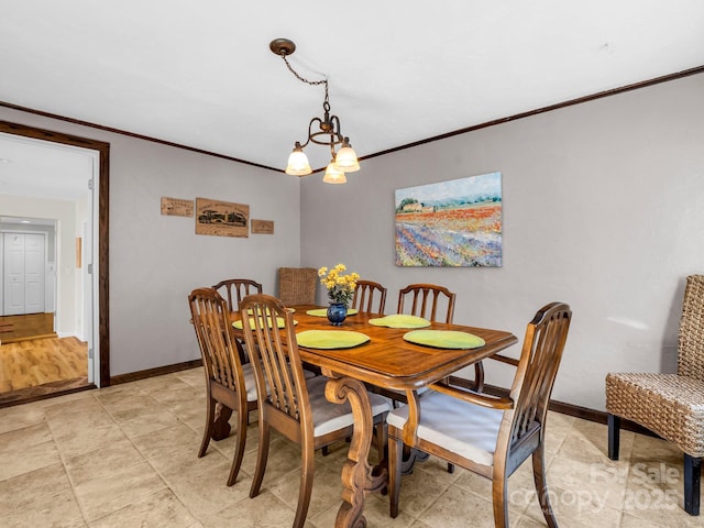 dining space featuring a notable chandelier and ornamental molding