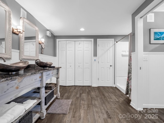 interior space featuring vanity, a shower with curtain, and wood-type flooring