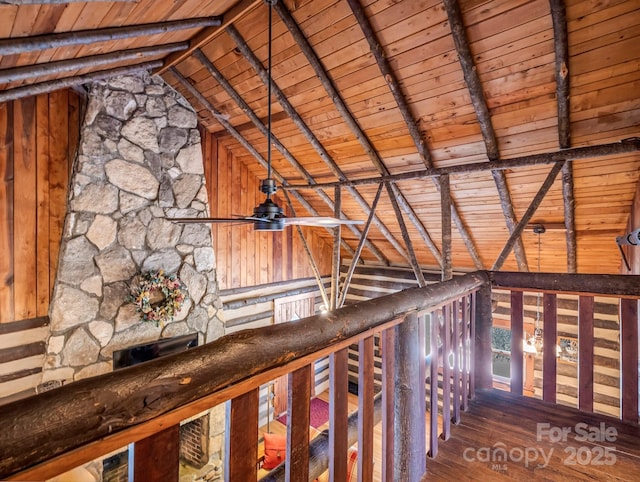 interior space with wood ceiling, ceiling fan, vaulted ceiling with beams, wooden walls, and wood-type flooring