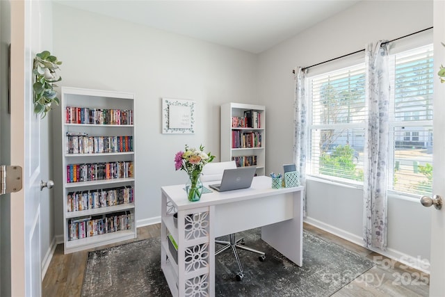 home office with dark hardwood / wood-style floors