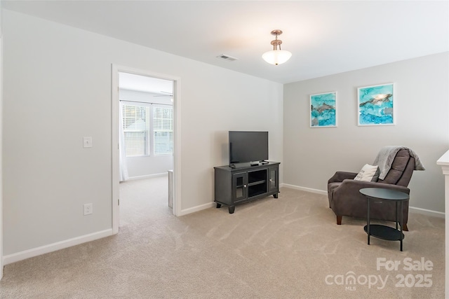 sitting room featuring light colored carpet