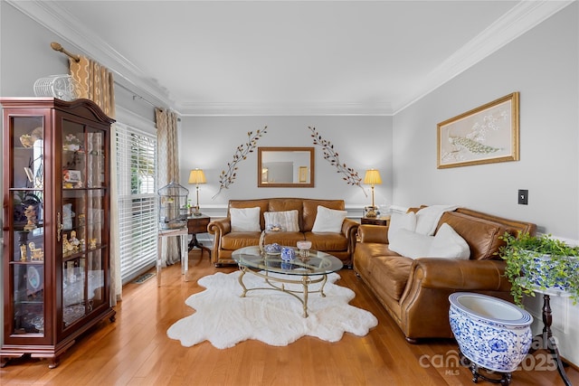 living room featuring crown molding and light wood-type flooring