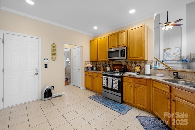 kitchen featuring sink, tasteful backsplash, light tile patterned floors, ornamental molding, and stainless steel appliances