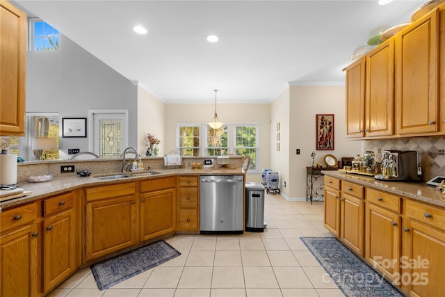 kitchen featuring hanging light fixtures, dishwasher, sink, and light tile patterned flooring