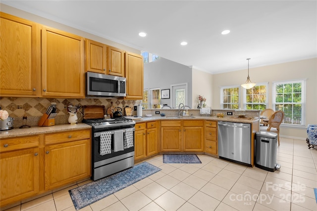 kitchen with light tile patterned flooring, sink, hanging light fixtures, appliances with stainless steel finishes, and backsplash