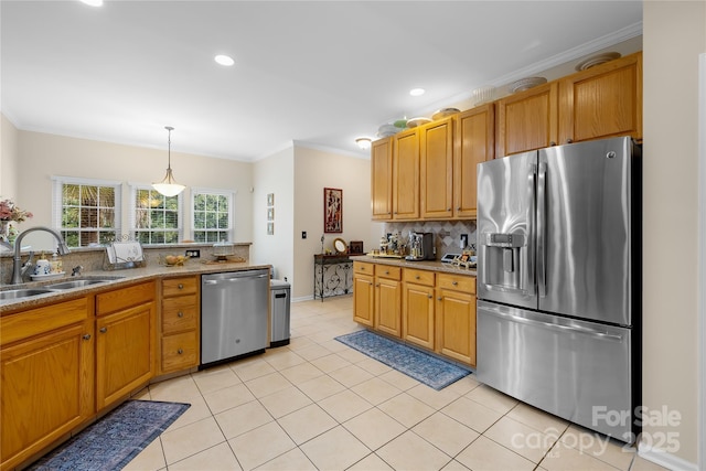 kitchen with sink, hanging light fixtures, light tile patterned floors, appliances with stainless steel finishes, and decorative backsplash