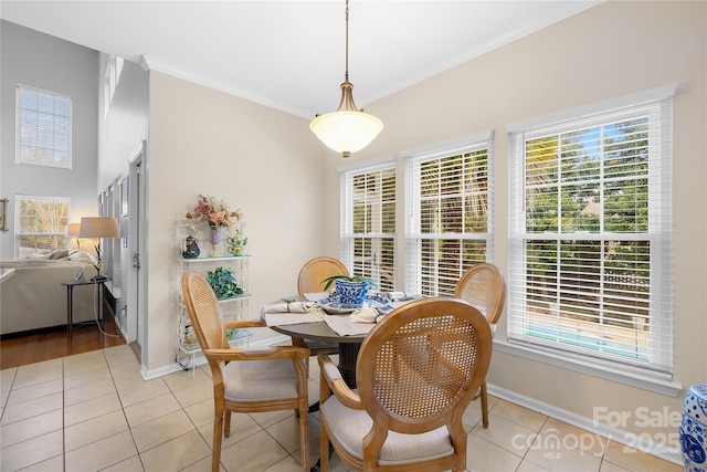 tiled dining area featuring crown molding