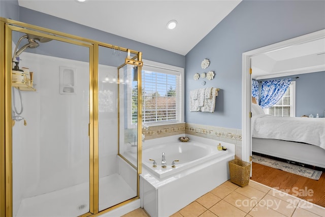 bathroom featuring lofted ceiling, tile patterned floors, and independent shower and bath