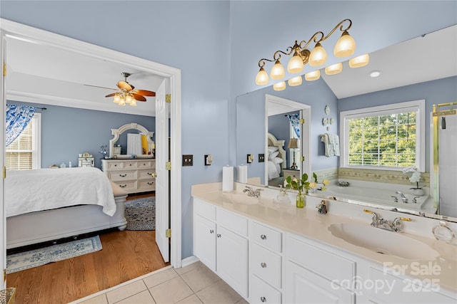 bathroom featuring vanity, a bathtub, tile patterned floors, and ceiling fan