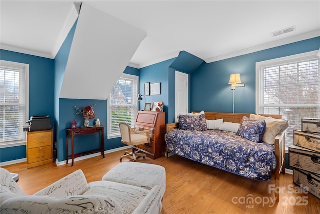 bedroom with multiple windows, ornamental molding, and hardwood / wood-style floors