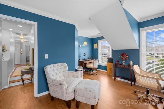 living area featuring wood-type flooring and ornamental molding