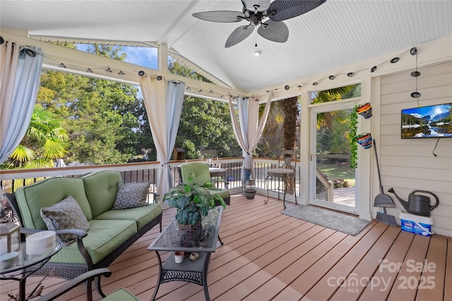 wooden terrace featuring an outdoor living space and ceiling fan