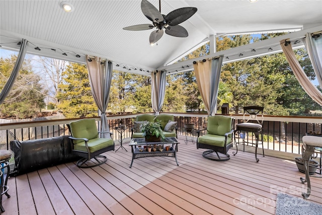 deck with outdoor lounge area and ceiling fan