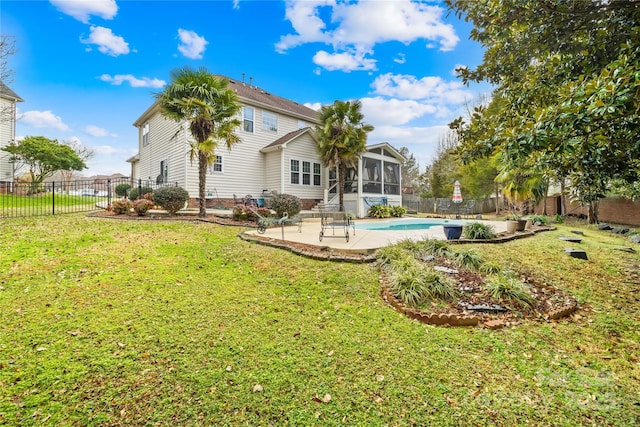 back of property featuring a fenced in pool, a sunroom, a yard, and a patio area