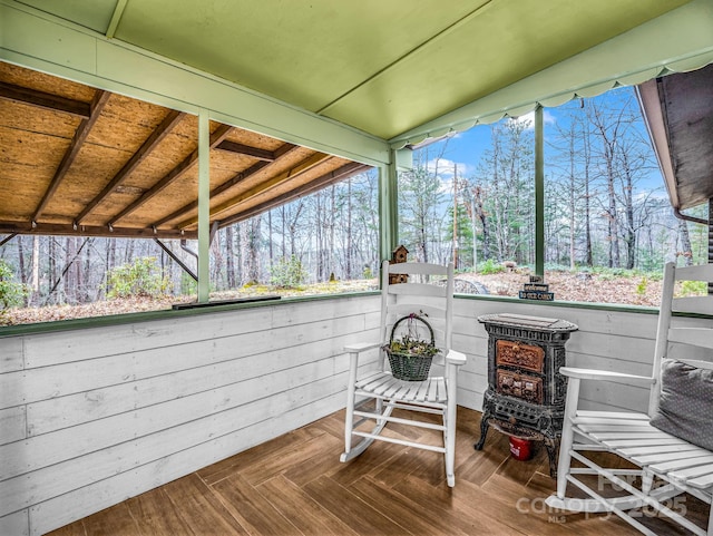 sunroom featuring a wood stove