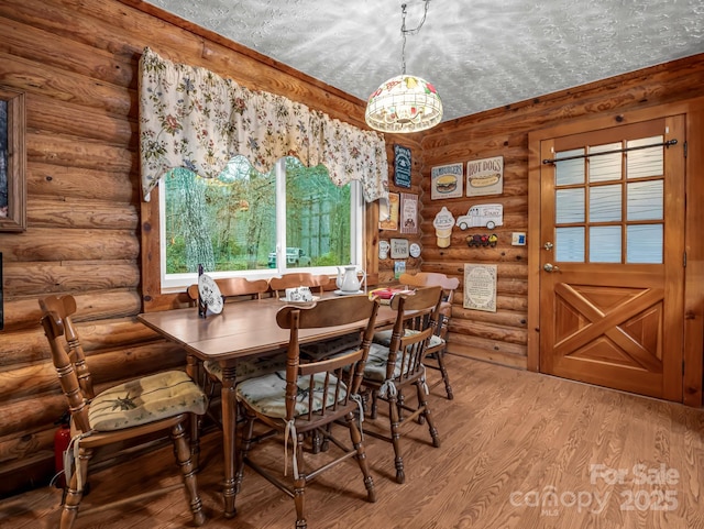 dining room with hardwood / wood-style flooring and a textured ceiling