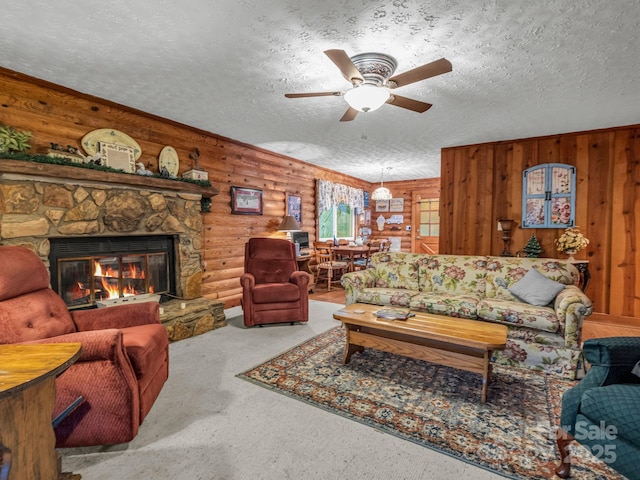 living room featuring a stone fireplace, rustic walls, carpet, and a textured ceiling