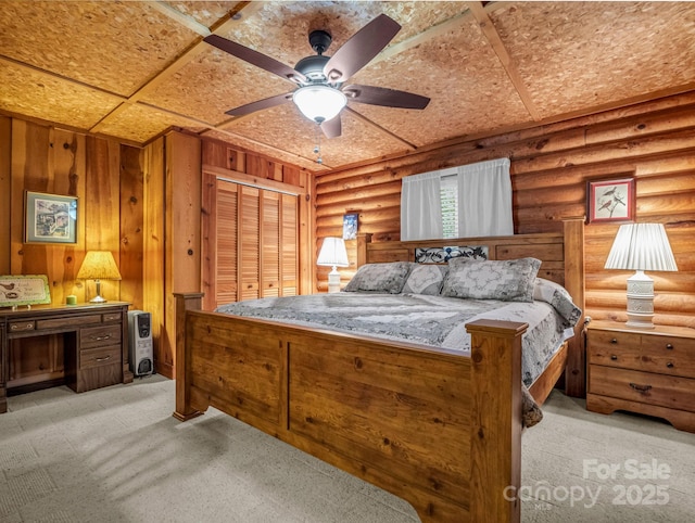 bedroom featuring light carpet, log walls, and ceiling fan