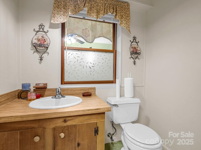 bathroom featuring vanity and toilet