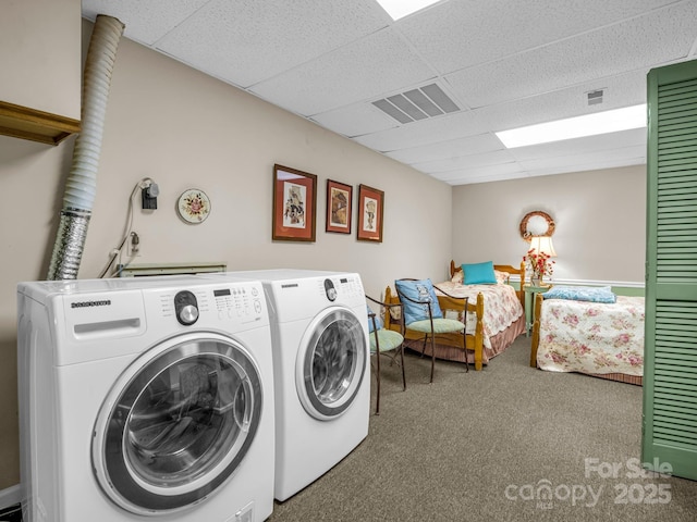 clothes washing area featuring cabinets, carpet, and washer and dryer