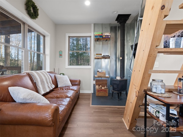 living room featuring wood-type flooring and a wood stove